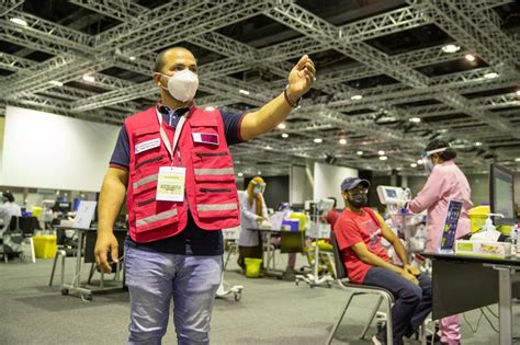 Qatar Charity distributes gifts to volunteers and vaccination centre .